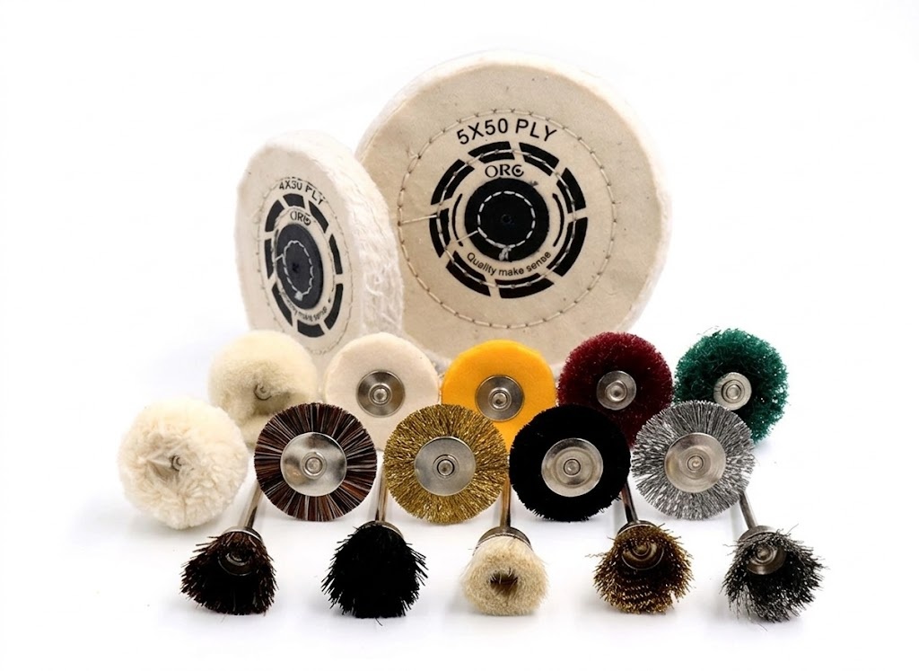 A collection of miniature polishing brushes, felt bobs, and wire wheels for professional jewelry detailing.