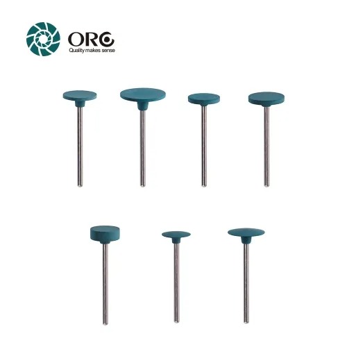 Seven teal green silicone rubber rotary polishers in various disk and cylinder shapes mounted on metal pins