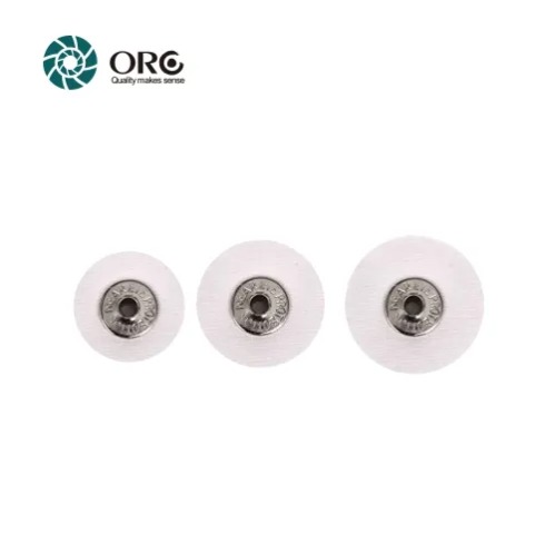 Three different sizes of ORO miniature white muslin buffing wheels for precision jewelry detailing.