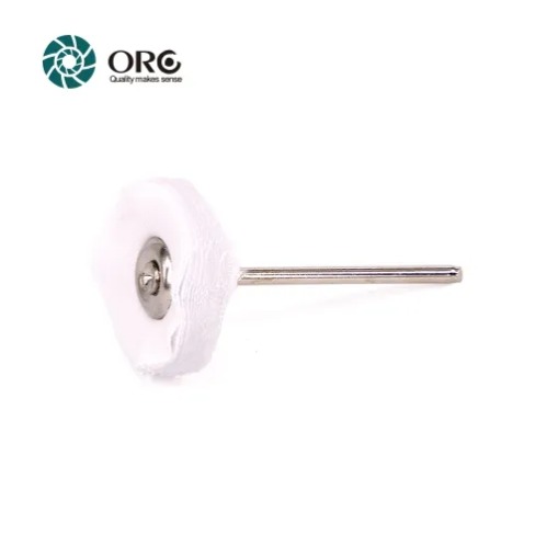 A small unstitched white cotton buffing wheel mounted on a silver steel shank mandrel for rotary tools.