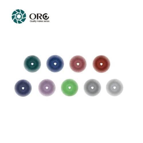 Nine different color-coded radial bristle discs displaying various grit options on a white background.