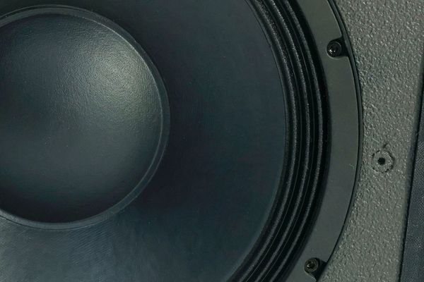 Why are woofer drivers easily burned out?