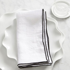 Stone washed linen cloth napkin with contrast color over lock stitch stripe napkin