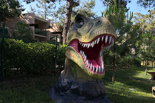 Estatua de cabeza de dinosaurio de fibra de vidrio para parques infantiles