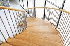 Wood Treads on white curved mono stringer curved staircase