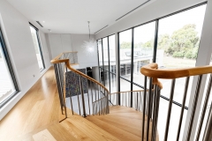 Wood Treads on white curved mono stringer curved staircase