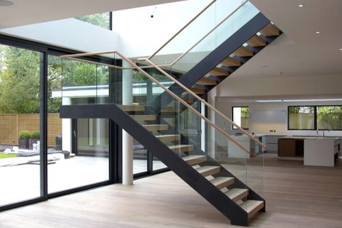Modern double stringer staircase with wood tread a...