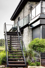 Exterior outdoor double stringer staircase with glass railing and wood tread