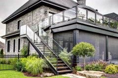 Exterior outdoor double stringer staircase with glass railing and wood tread