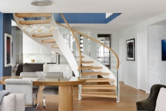 Modern floating curved staircase with glass railings