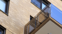 Tinted glass railing with stainless steel baluster and wood handrail