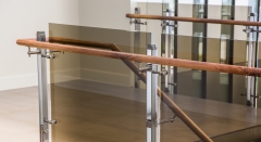 Tinted glass railing with stainless steel baluster and wood handrail
