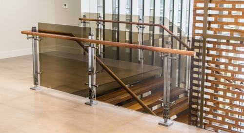 Tinted glass railing with stainless steel baluster and wood handrail