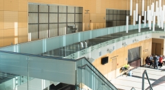 Frameless pitch fittings glass railing with steel standoff for corridor