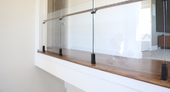 Black spigot glass railing frameless with solid wood handrail