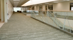 Modern glass railing with u channel aluminum for commercial corridor