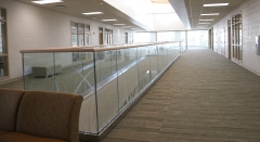 Modern glass railing with u channel aluminum for commercial corridor