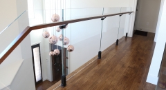 Black spigot glass railing frameless with solid wood handrail