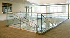 Modern glass railing with u channel aluminum for commercial corridor