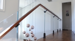 Black spigot glass railing frameless with solid wood handrail