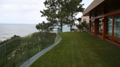 Curved frameless glass railing with aluminum u base channel for exterior