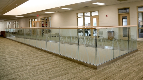 Modern glass railing with u channel aluminum for commercial corridor