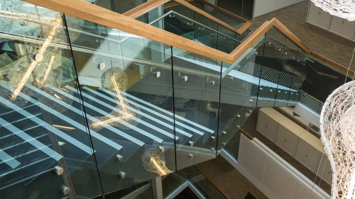 Staircase glass railing with stainless pitch fittings wood handrail