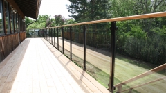 Glass railing with black steel baluster for balcony design