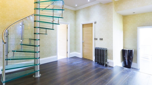 Helical glass staircase with glass railings for indoor