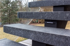 Exterior stone steps staircase with glass railing