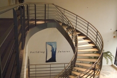 Curved staircase design with steel black balustrade