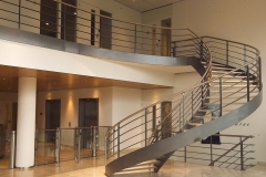 Curved staircase design with steel black balustrade