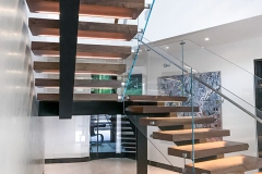 Mono beam staircase with glass railing and LED strip light