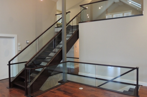 Modern open tread straight staircase with glass balustrade