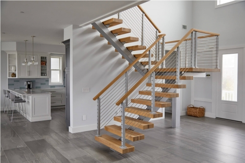 Indoor mono stringer staircase with cable railing and wood handrail