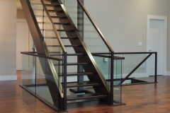 Modern open tread straight staircase with glass balustrade