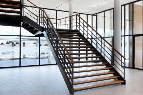Double stringer free standing stair with black steel balustrade