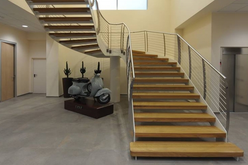 Double staircase with steel rod railing and curved middle landing