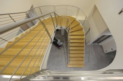 Double staircase with steel rod railing and curved middle landing