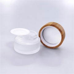 Cosmetic glass cream jar with bamboo lid