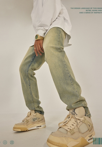 Autumn and winter yellow mud-colored slit jeans