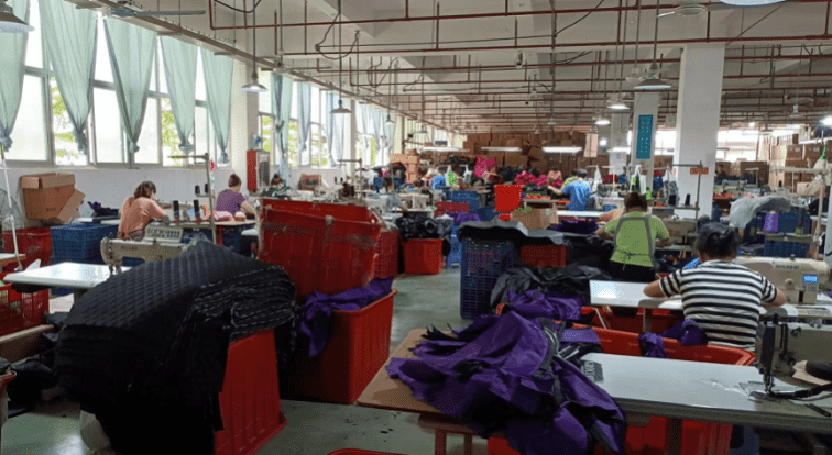 Factory employees who customize bags and suitcases make canvas bags