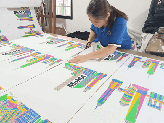 Workers are cutting digital printed canvas bags