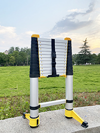 a soft close aluminium telescopic ladder is self-standing in the park