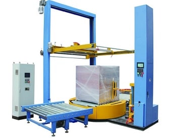 conveyorized pallet wrapper with top film dispenser