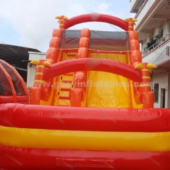 Orange inflatable bouncy castle with water double slides