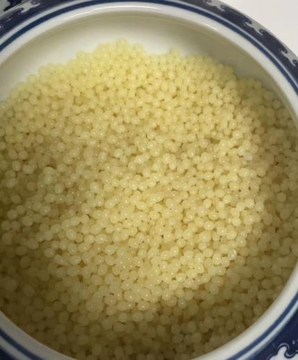 Light yellow edge‑banding hot melt glue particles
