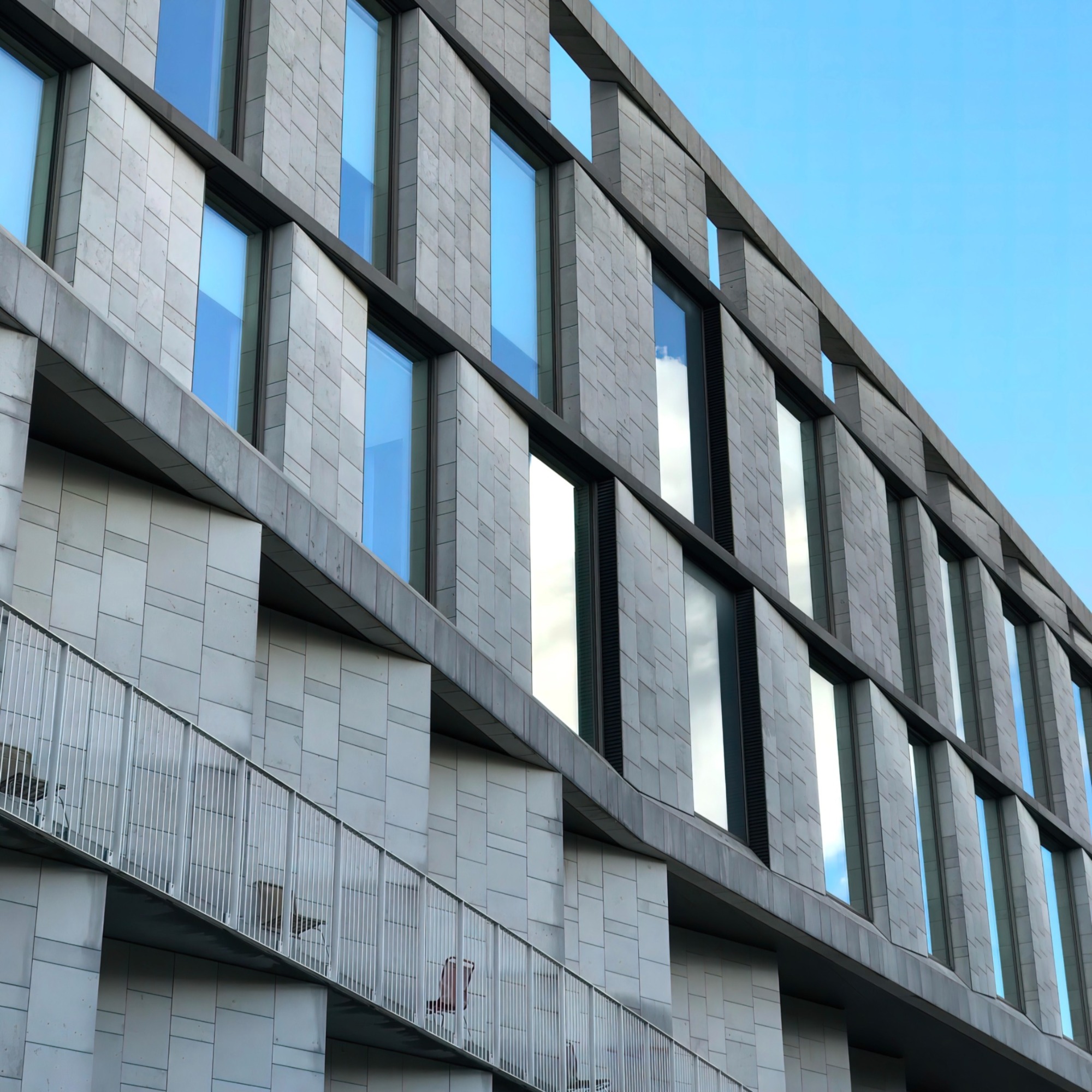 Weather-resistant UV-coated stone effect wall cladding for modern commercial building exterior
