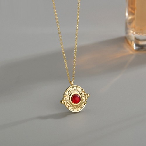 Vintage sunburst medallion with red agate necklace in steel