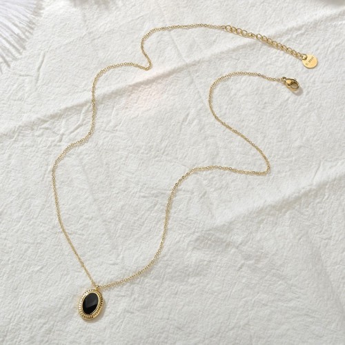 Gold and black resin medallion necklace in stainless steel